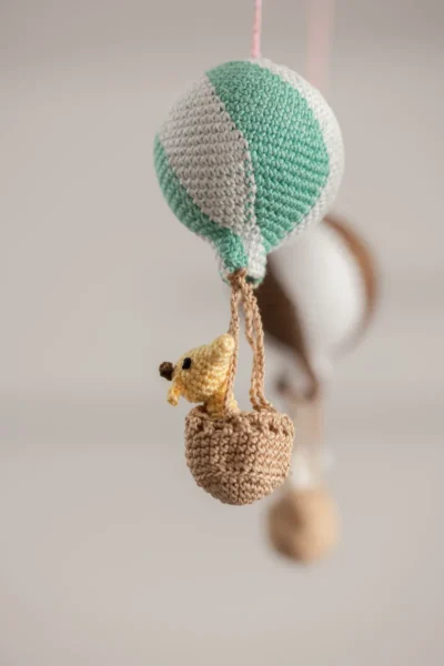 Handmade crochet zoo animal nursery mobile featuring colourful crochet animals made by artisan women in India Australia