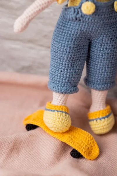 Close up of handmade crochet boy doll face showing hand stitched features and soft yarn texture artisan made soft toy Australia