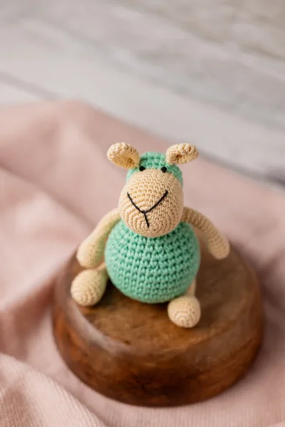 Aster the sheep crochet toy seated upright on nursery shelf showing soft white woolly texture ethical handmade gift Melbourne
