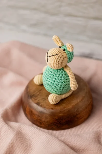 Full body view of crochet sheep soft toy Aster showing round amigurumi body neat limbs and textured woolly coat Melbourne