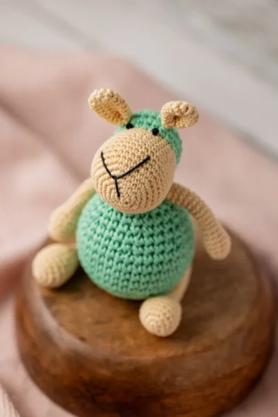 Full body view of crochet sheep soft toy Aster showing round amigurumi body neat limbs and textured woolly coat Melbourne