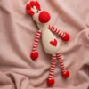 Handmade crochet Azizi giraffe soft toy with warm spot pattern long neck and gentle embroidered face made by artisan crafters Australia