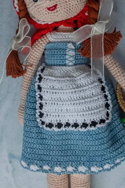 Bella the doll full body view showing soft crochet cotton yarn dress and hand stitched features ethical handmade toy Melbourne