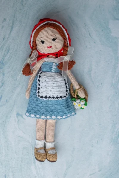 Bella the doll full body view showing soft crochet cotton yarn dress and hand stitched features ethical handmade toy Melbourne
