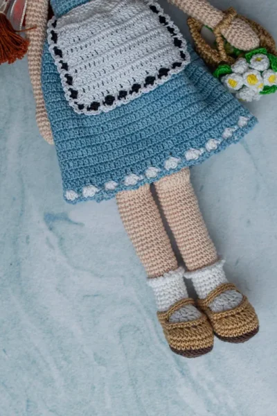 Bella the doll full body view showing soft crochet cotton yarn dress and hand stitched features ethical handmade toy Melbourne