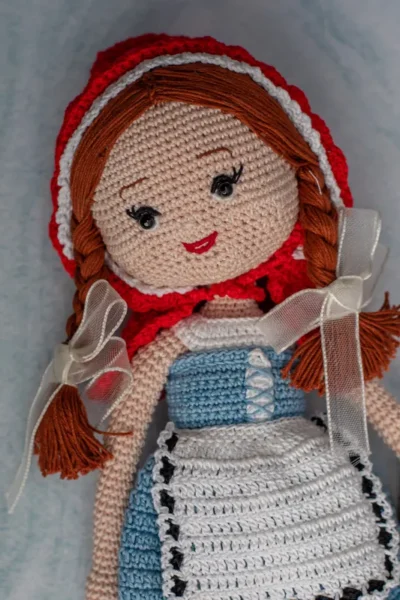 Bella the doll full body view showing soft crochet cotton yarn dress and hand stitched features ethical handmade toy Melbourne