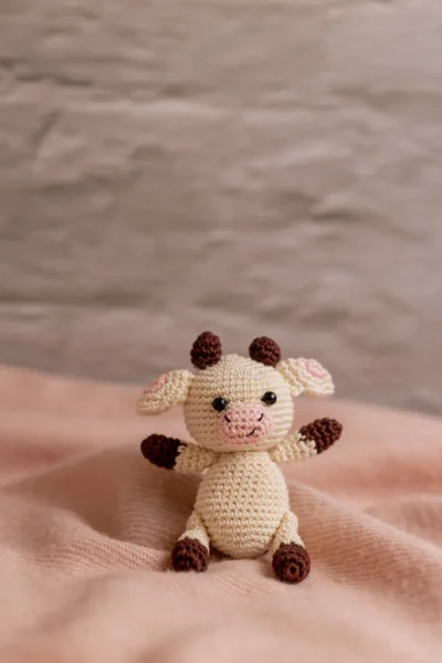 Handmade crochet cow rattle and toy set with soft cow companion and matching rattle made by artisan crafters newborn gift Australia