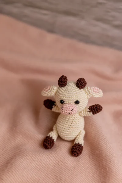 Handmade crochet cow rattle and toy set with soft cow companion and matching rattle made by artisan crafters newborn gift Australia