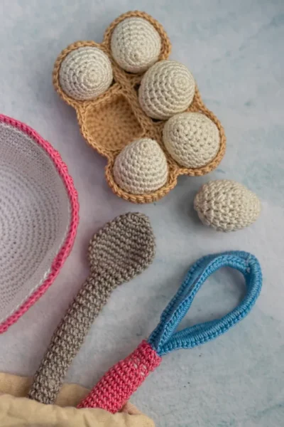 Full 6 piece crochet baking set laid out showing all pieces baker doll bowl eggs and whisk handmade kids gift Melbourne