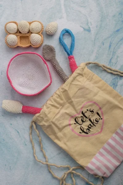 Full 6 piece crochet baking set laid out showing all pieces baker doll bowl eggs and whisk handmade kids gift Melbourne