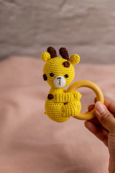 Crochet giraffe rattle and toy set styled in nursery context ethical handmade baby gift Melbourne Australia