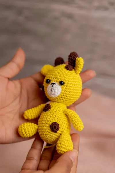 Crochet giraffe rattle and toy set styled in nursery context ethical handmade baby gift Melbourne Australia