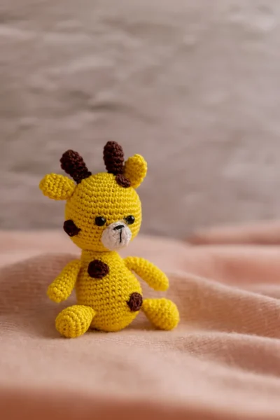 Crochet giraffe rattle and toy set styled in nursery context ethical handmade baby gift Melbourne Australia