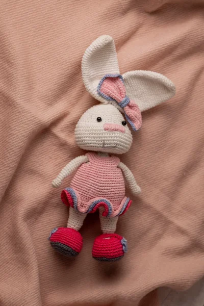 Handmade crochet amigurumi bunny rabbit in pink dress with matching bow made by artisan crafters soft toy gift Australia