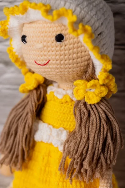 Handmade amigurumi doll in yellow floral dress styled on shelf keepsake soft toy gift shipped from Melbourne Australia