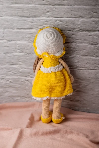 Handmade amigurumi doll in yellow floral dress styled on shelf keepsake soft toy gift shipped from Melbourne Australia