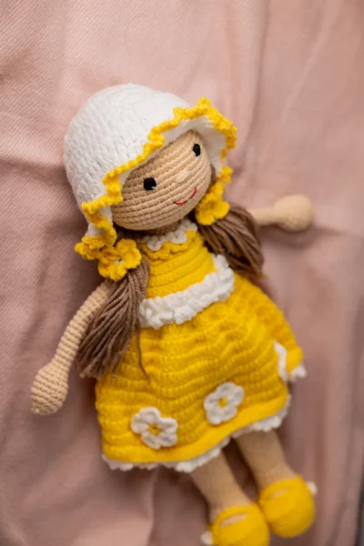 Handmade amigurumi doll in yellow floral dress styled on shelf keepsake soft toy gift shipped from Melbourne Australia