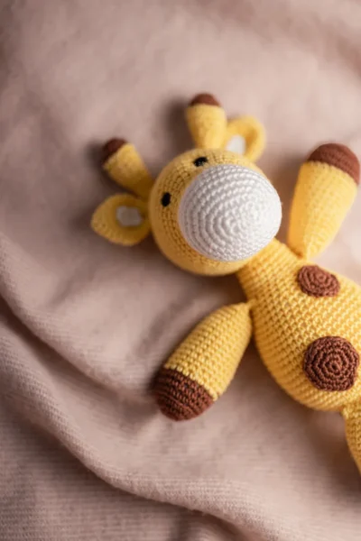 Handmade crochet Boban giraffe soft toy in warm yellow and brown tones made by artisan women in India kids gift Australia