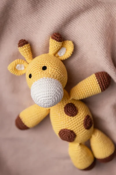 Handmade crochet Boban giraffe soft toy in warm yellow and brown tones made by artisan women in India kids gift Australia