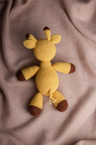 Close up of handmade crochet Boban giraffe face showing hand stitched features soft yarn texture artisan made baby gift Australia